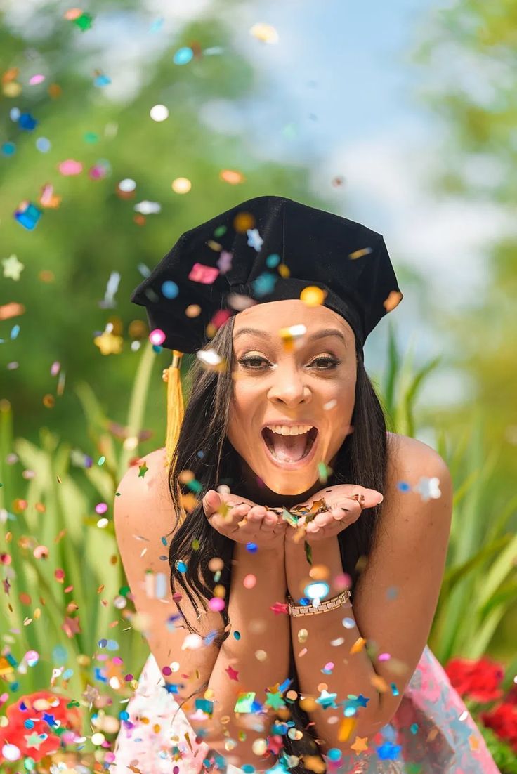 a woman wearing a graduation cap and gown surrounded by confetti