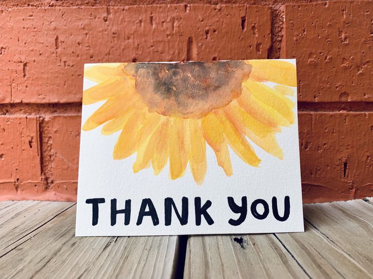 a card with the words thank you written on it and a sunflower painted on it