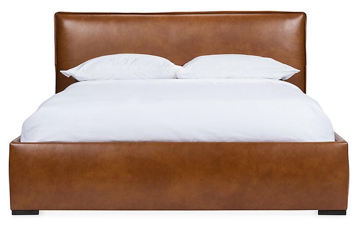 a bed with white pillows and brown leather headboard, on an isolated white background