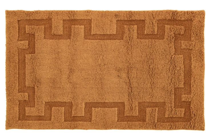 a brown rug with an interlocked design on the front and back side,