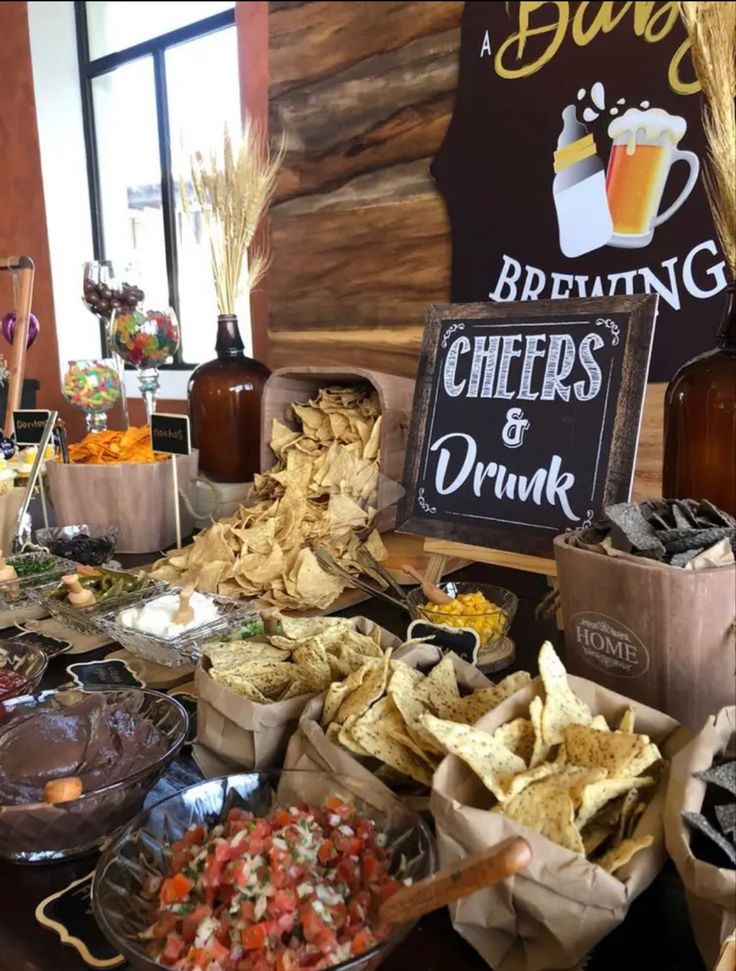 a table full of chips and beer at a bar