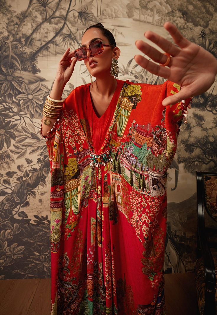 Editor's Note Featuring a vibrant printed kaftan with a v-neckline. It has an intricately handcrafted beadwork patch on the waistline. Fabric: Crepe Color: Orange Components: Kaftan Occasion: Daywear and resort Care: Dry Clean Only About the Designer Kalista is a luxury fashion label that specializes in designer clothing for millennial women. Founded by fashion designer turned entrepreneur, Pratyush Guglani, this indigenously curated label puts its own spin on ethnic and fusion couture. Their lu Orange Kaftan, Blouse Yoke, Kaftan For Women, Printed Kaftan, Patchwork Coat, Personal Shopping Service, Kimono Pattern, Exotic Fashion, Cotton Linen Dresses