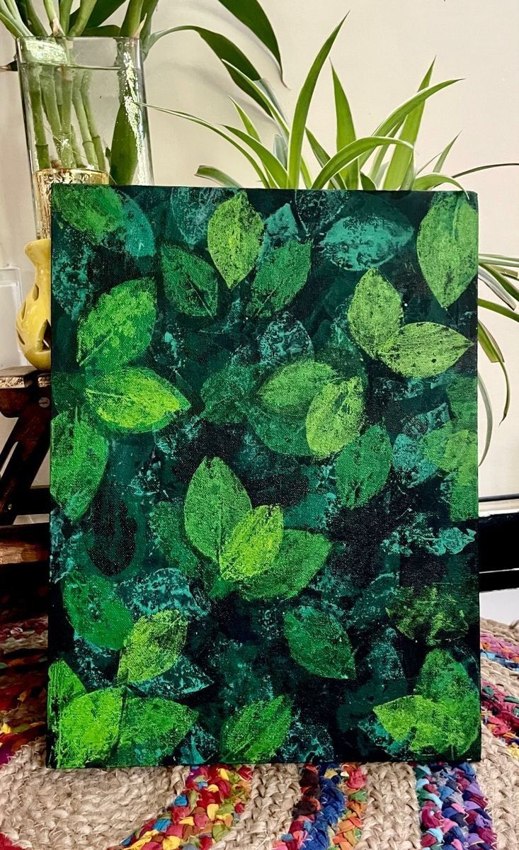 a painting with green leaves on it