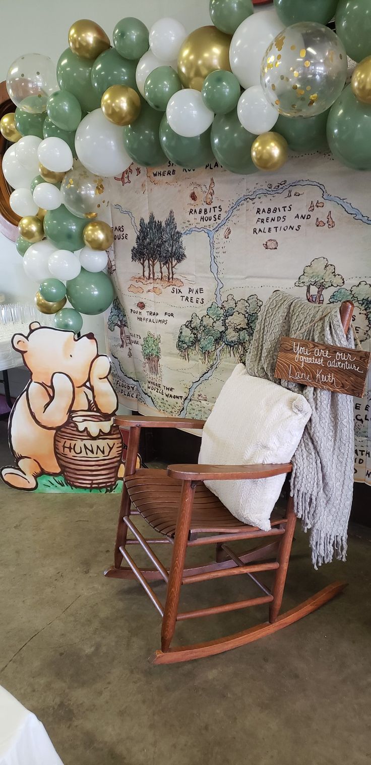 a rocking chair in front of a wall with balloons