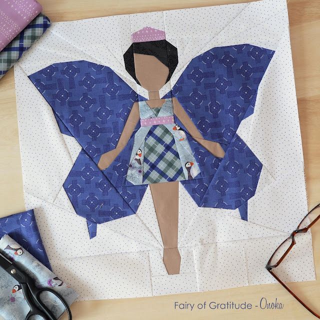 the paper doll is made to look like a butterfly