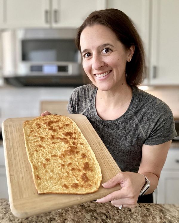 a woman holding a tray with food on it