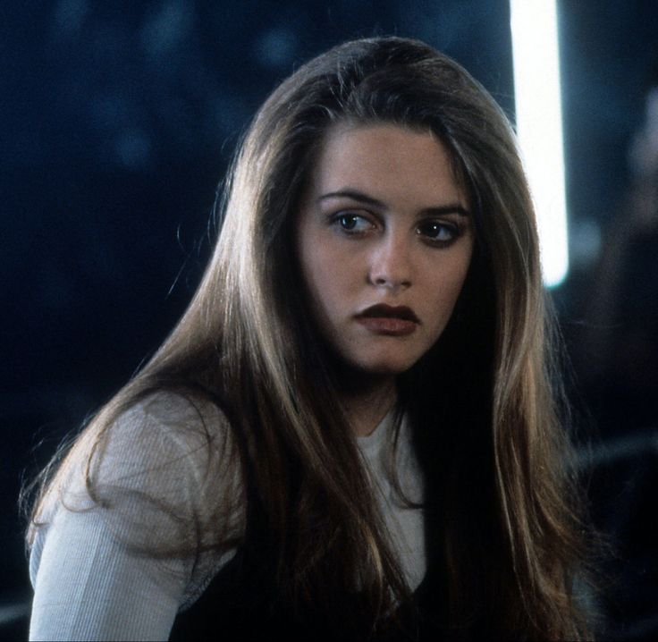 a woman with long brown hair is staring at the camera