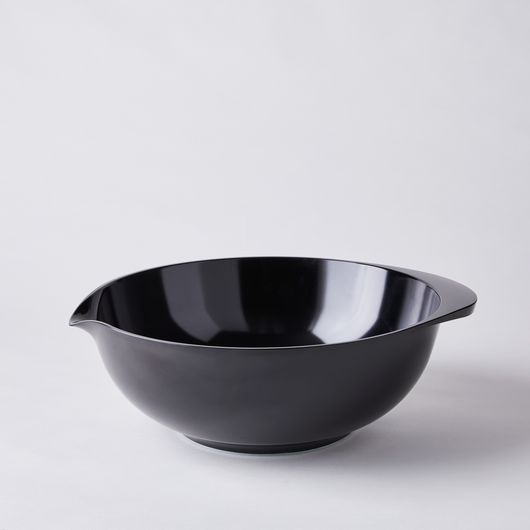 a black bowl sitting on top of a white table