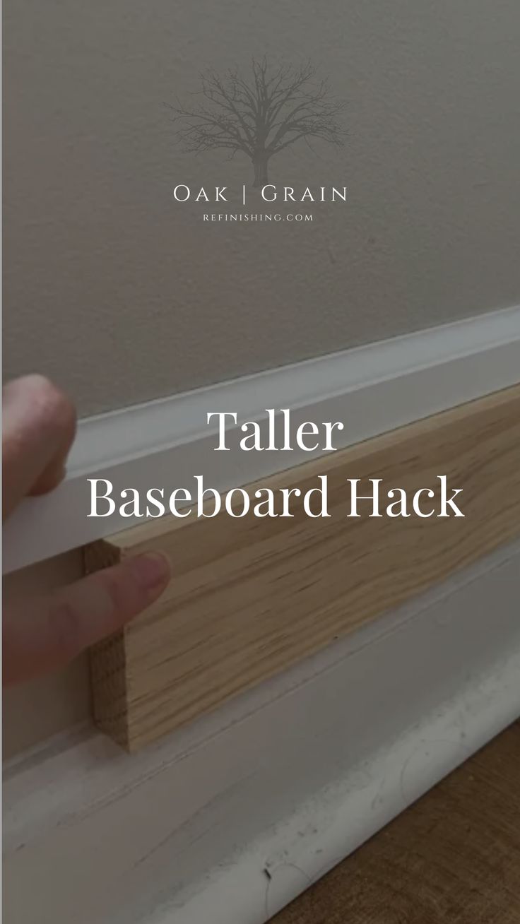 a hand is holding the edge of a baseboard with text overlay that reads, taller baseboard hack