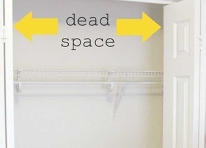 a closet with two yellow arrows pointing to the dead space