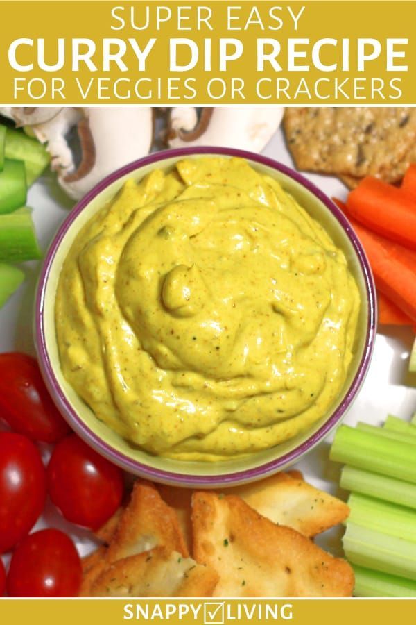 a bowl filled with guacamole surrounded by vegetables and crackers