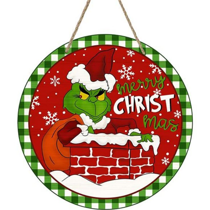 a christmas sign hanging from the side of a brick wall with an image of dr seuss