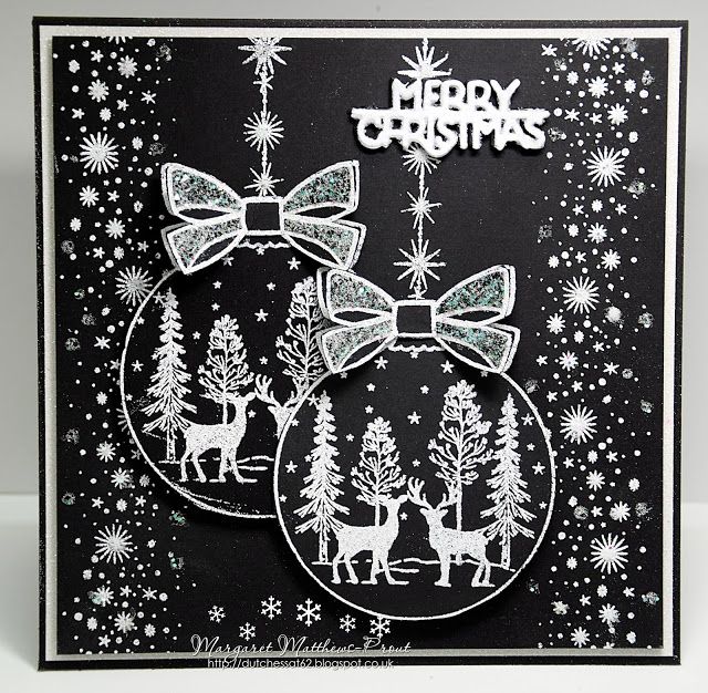 a black and white christmas card with two ornaments