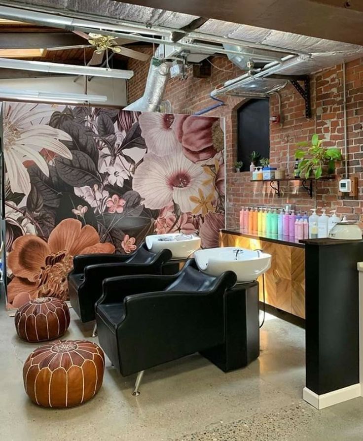 a salon with lots of furniture and flowers on the wall