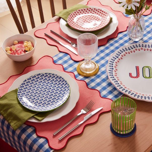 the table is set with plates, bowls and utensils