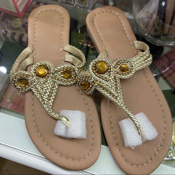 New In Package. Medium (7-8). Braids Of Paradise Thong Sandals. Gold Color. Trendy Gold Flip Flops For Summer, Gold Slippers For Summer, Gold Toe Post Flip Flops For Vacation, Gold Flat Casual Flip Flops, Casual Closed Toe Gold Flip Flops, Casual Gold Closed Toe Flip Flops, Summer Vacation Toe Loop Slippers, Gold Summer Slippers, Toe Post Flip Flops For Summer Outings