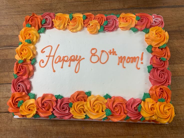 a birthday cake decorated with flowers and the words happy 80th mom