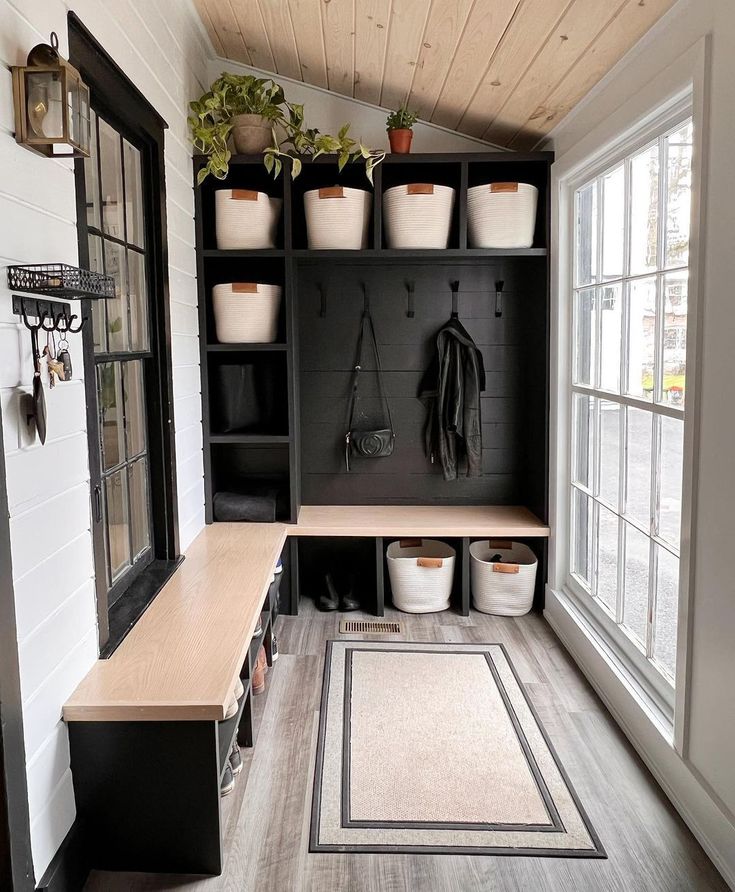 the inside of a small room with several pots and plants on shelves, along with other items