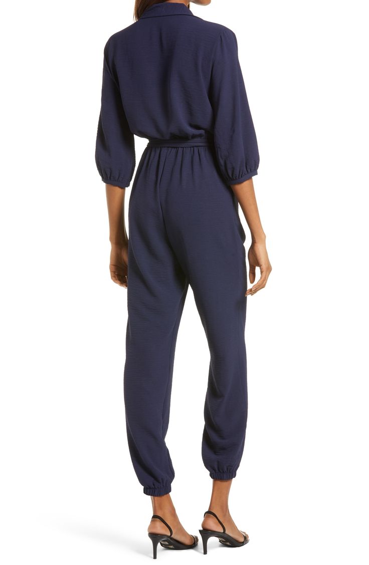 The jumpsuit trend is, well, hopping, and this option, styled with an easy tied waist and elastic cuffs, is a winning way to wear the look. 58" length; 30" inseam; 10" leg opening (size Medium) Front button-and-loop closure Surplice V-neck with spread collar Long sleeves Elastic cuffs and waist Front slant pockets Removable tie belt Partially lined 100% polyester Hand wash, line dry Made in the USA Women's Clothing Overall Jumpsuits And Rompers With Elastic Waistband For Loungewear, Chic Jumpsuit With Elastic Waistband For Loungewear, Chic Jumpsuits And Rompers With Elastic Waistband For Loungewear, Chic Loungewear Jumpsuits With Elastic Waistband, Chic Loungewear Jumpsuits And Rompers With Elastic Waistband, Workwear Jumpsuit With Tie Waist And Relaxed Fit, Relaxed Fit Jumpsuit With Elastic Waistband For Loungewear, Casual Spring Jumpsuits And Rompers With Belted Cuffs, Casual Fitted Jumpsuits And Rompers With Belted Cuffs