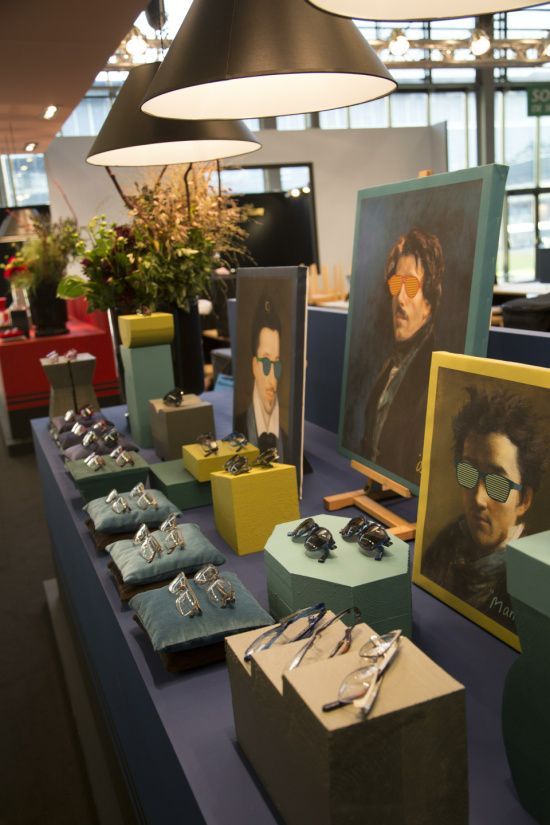 the table is covered with paintings and jewelry