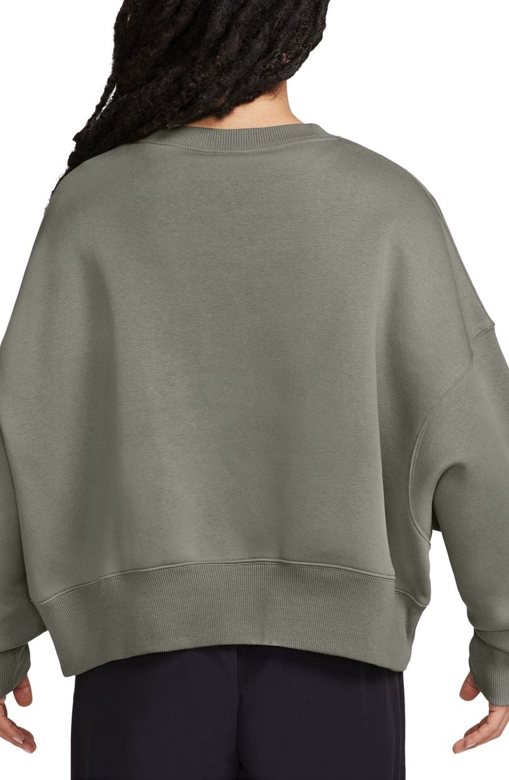 An embroidered Swoosh adds minimal branding to this cozy fleece sweatshirt cut for a relaxed, oversized fit that's enhanced by the dropped shoulders. 22" length (size Medium) Crewneck 80% cotton, 20% polyester Machine wash, tumble dry Imported Cozy Nike Cotton Sweats, Cozy Nike Sweats, Cozy Cotton Nike Sweats, Nike Cotton Crew Sweats, Nike Relaxed Fit Fleece Sweats, Nike Cotton Sweatshirt For Loungewear, Nike Solid Color Sweats For Fall, Nike Solid Sweats For Fall, Nike Solid Color Fall Sweats