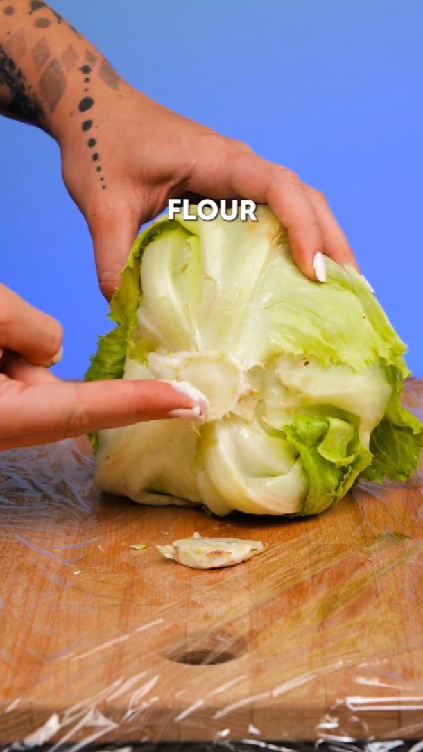 a person cutting up lettuce on top of a wooden table with the words flour written above it