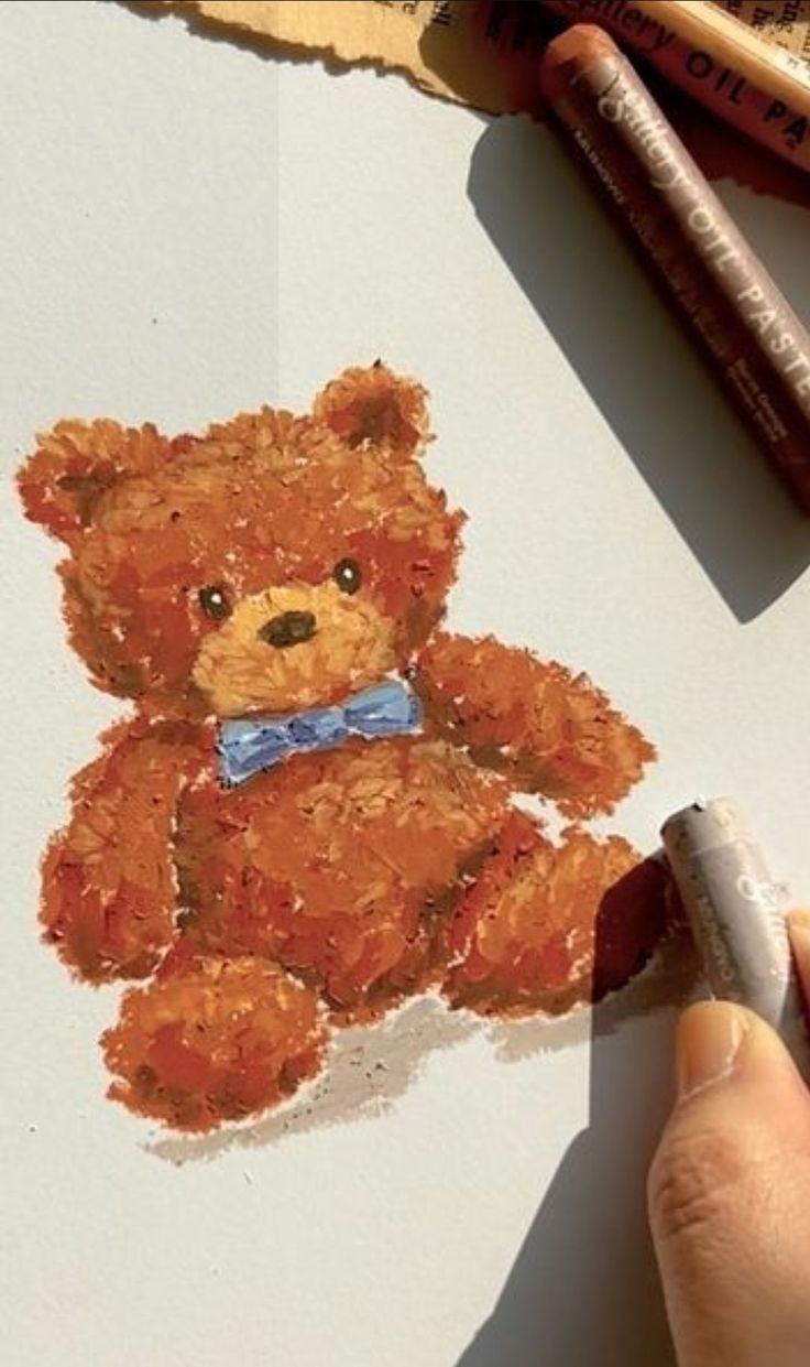 someone is drawing a teddy bear with crayons