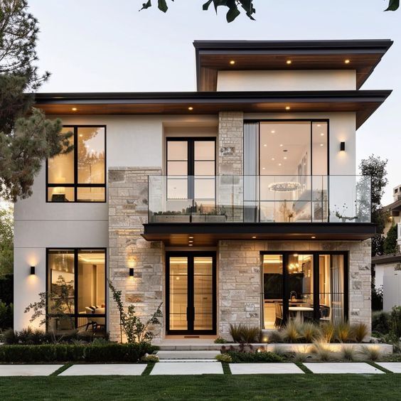 a large modern house with lots of windows and balconies on the second floor