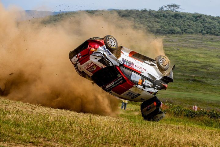 a car that is upside down in the air with dirt on it's side