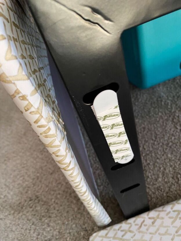 a close up of a black and white object on the ground next to a chair