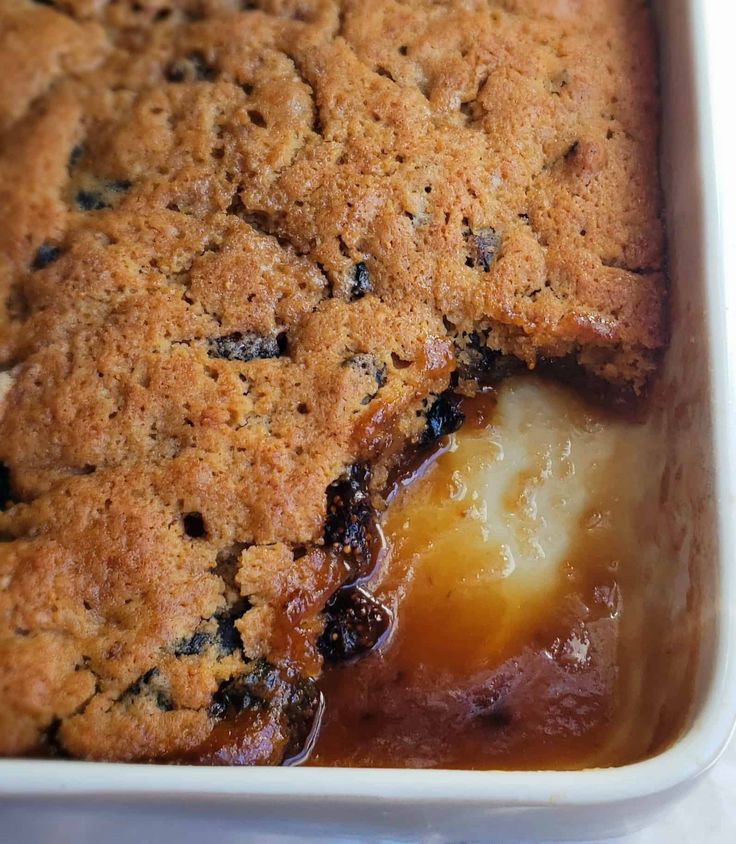 a close up of a casserole in a pan with some fruit on it