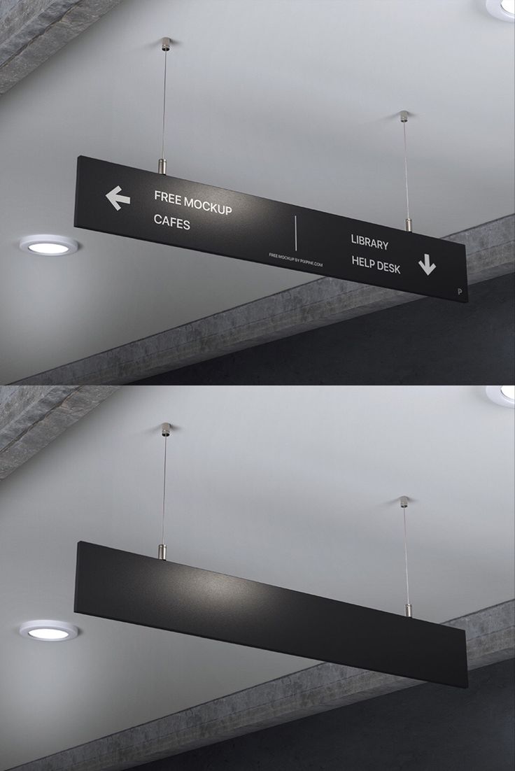 two black and white signs hanging from the ceiling in a room with lights on it