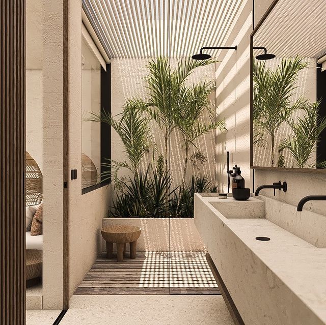 a bathroom with two sinks and plants in the shower area, along with a large mirror on the wall