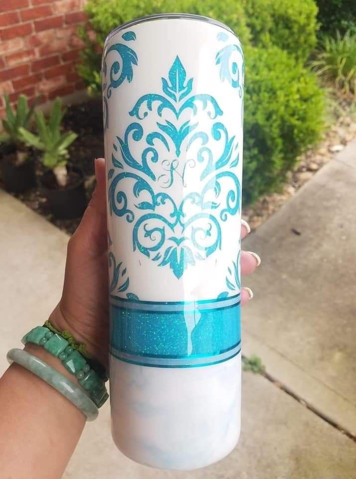 a person holding up a white and blue cup