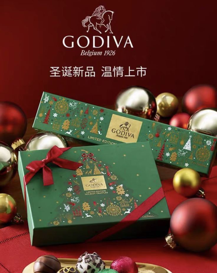 an advertisement for godiva's christmas chocolates with ornaments and decorations in the background