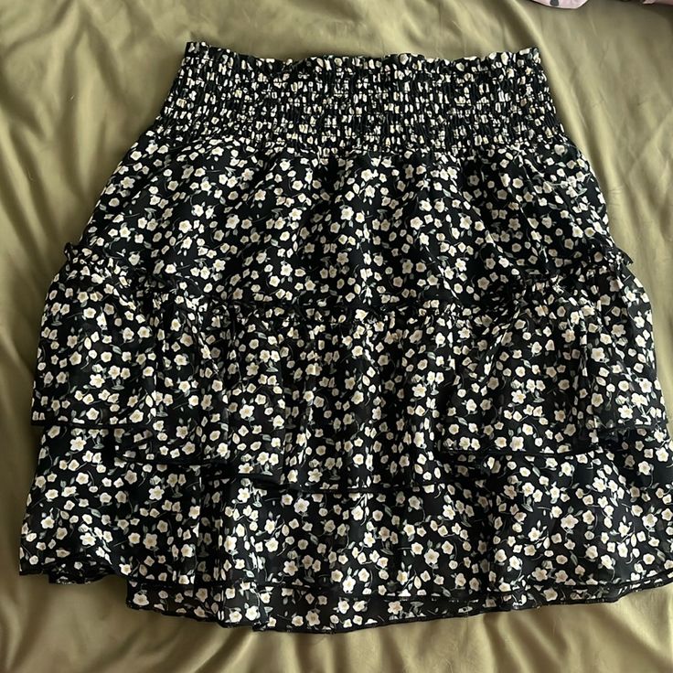 Perfect Condition Ruffle Skirt Never Worn But No Tags. Very Comfortable And True To Size Casual Tiered Skirt Bottoms With Floral Print, Casual Floral Print Tiered Skirt Bottoms, Casual Black Mini Skirt For Spring, Black Skirt For Spring Vacation, Casual Mini Skirt With Floral Print, Black Ruffle Hem Mini Skirt, Black Gathered Skort For Summer, Black Gathered Skirt For Day Out, Black Ruffle Hem Mini Skirt For Spring