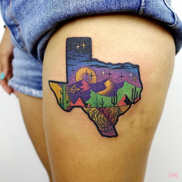 a woman's thigh with a colorful texas map tattoo design on the lower leg