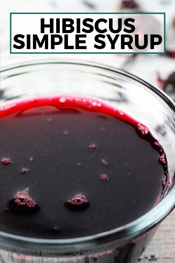 a glass bowl filled with red liquid and the words hirscuss simple syrup