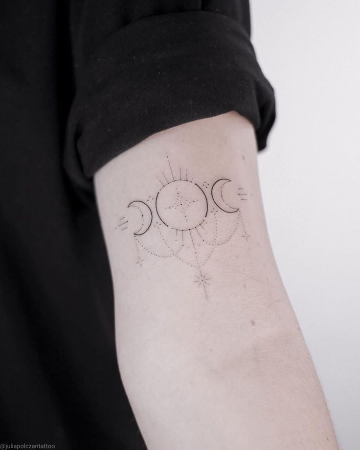 a woman's arm with three phases of the moon and sun tattoo on it