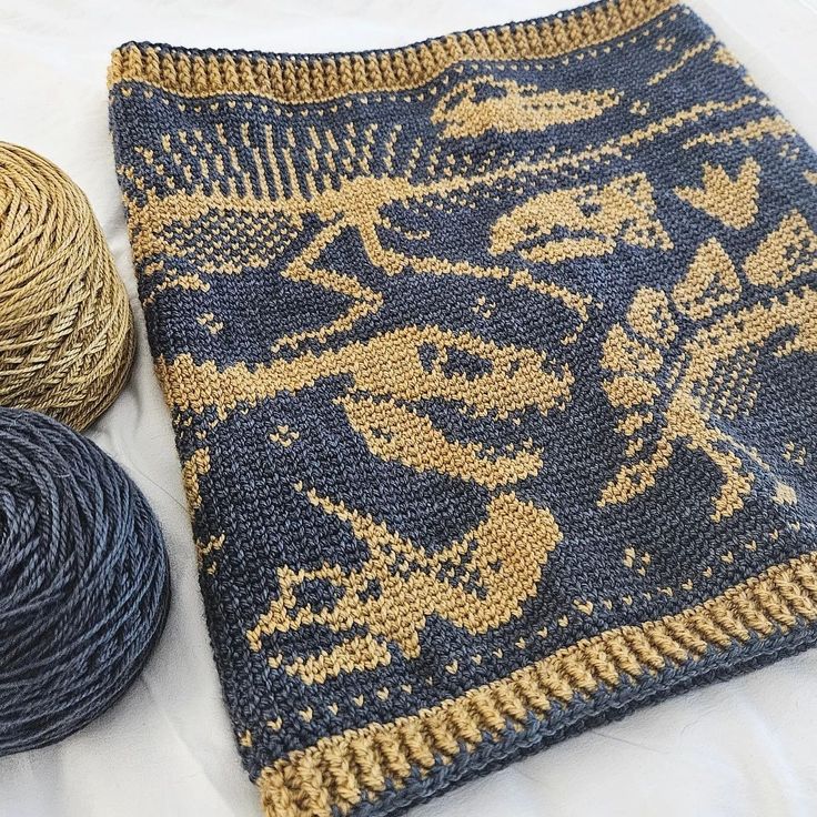 two skeins of yarn sitting next to each other on a white tablecloth