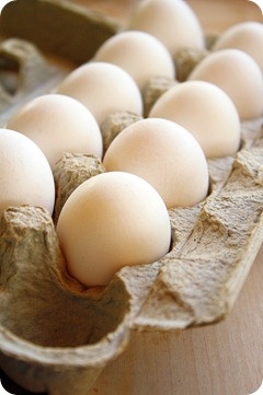 an egg carton filled with eggs sitting on top of a wooden table