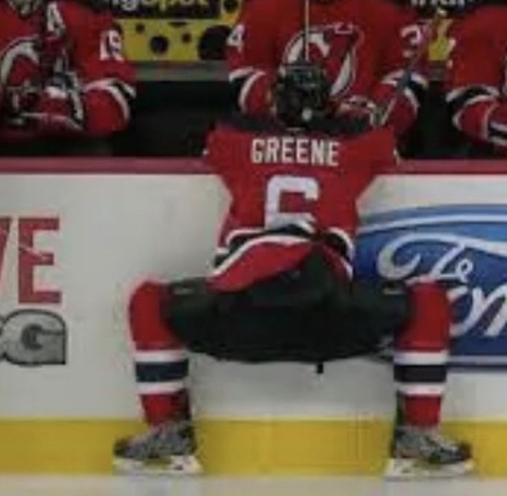 the hockey players are sitting on the bench