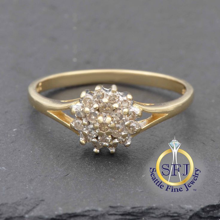 "Restored Vintage Diamond Cluster Ring, Solid 14K Yellow Gold METAL: Solid Yellow Gold, Stamped 14K MAIN GEM: Diamonds-- 19 Round. Total  0.24 carats CURRENT RING SIZE:  7 (Expert resizing service available. Safe resize range for this ring: 5--9. See below to purchase resizing.) APPRAISED VALUE: $925 In this ring, a split shank style opens up to the center cluster of diamonds. A total of nineteen diamonds are arranged in a cluster, as a double halo around the dainty center diamond. This is a qua Classic Cluster Ring With Center Stone, Classic Cluster Rings With Single Cut Diamonds, Diamond Cluster Birthstone Ring With Center Stone, Formal Gold Diamond Ring With Round Stone, Gold Birthstone Ring With Halo Setting For Formal Occasions, Cluster Birthstone Ring With Center Stone For Anniversary, Classic Cluster Promise Ring, Fine Jewelry Anniversary Cluster Ring With Prong Setting, Collectible Cluster Ring With Brilliant Cut