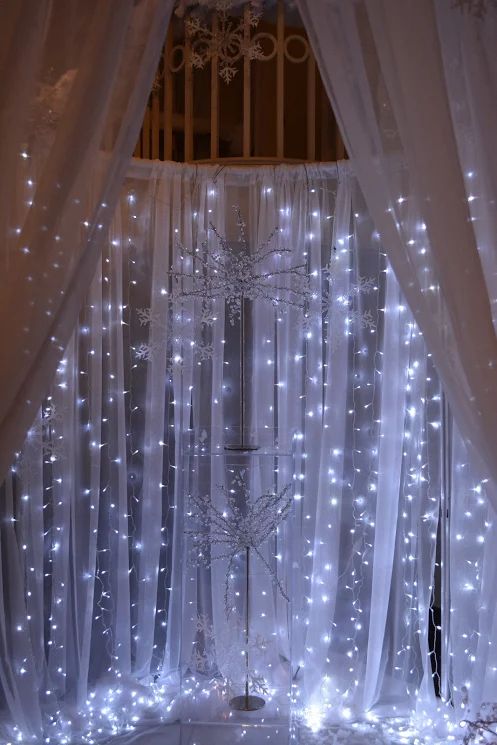 a white curtain with lights hanging from it