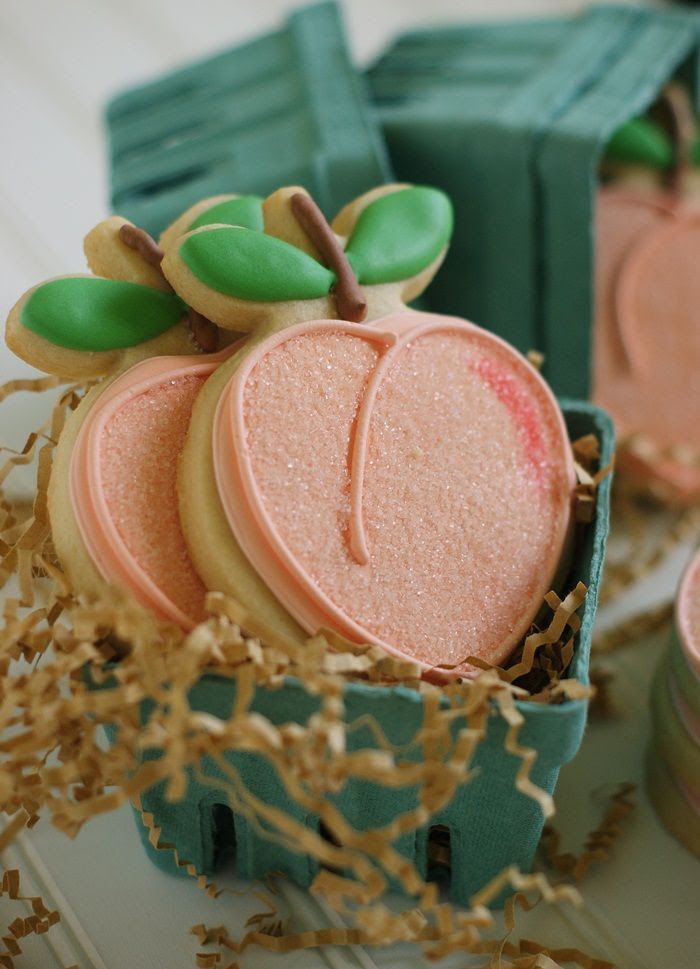 there are some cookies in the shape of apples inside of an apple shaped cookie box