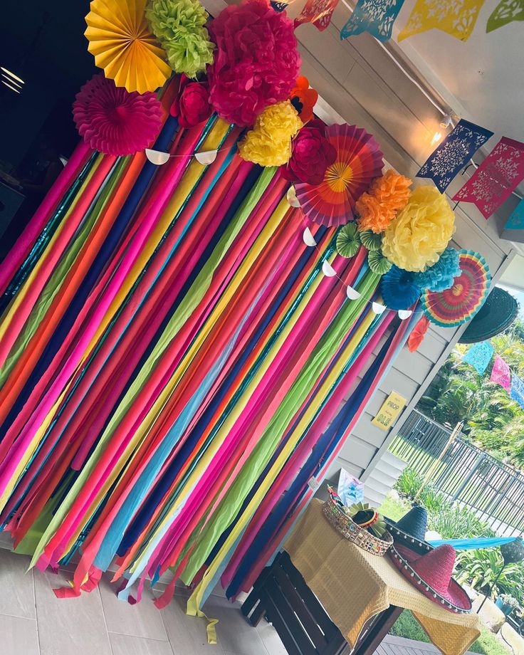 colorful paper flowers and streamers hanging from the ceiling