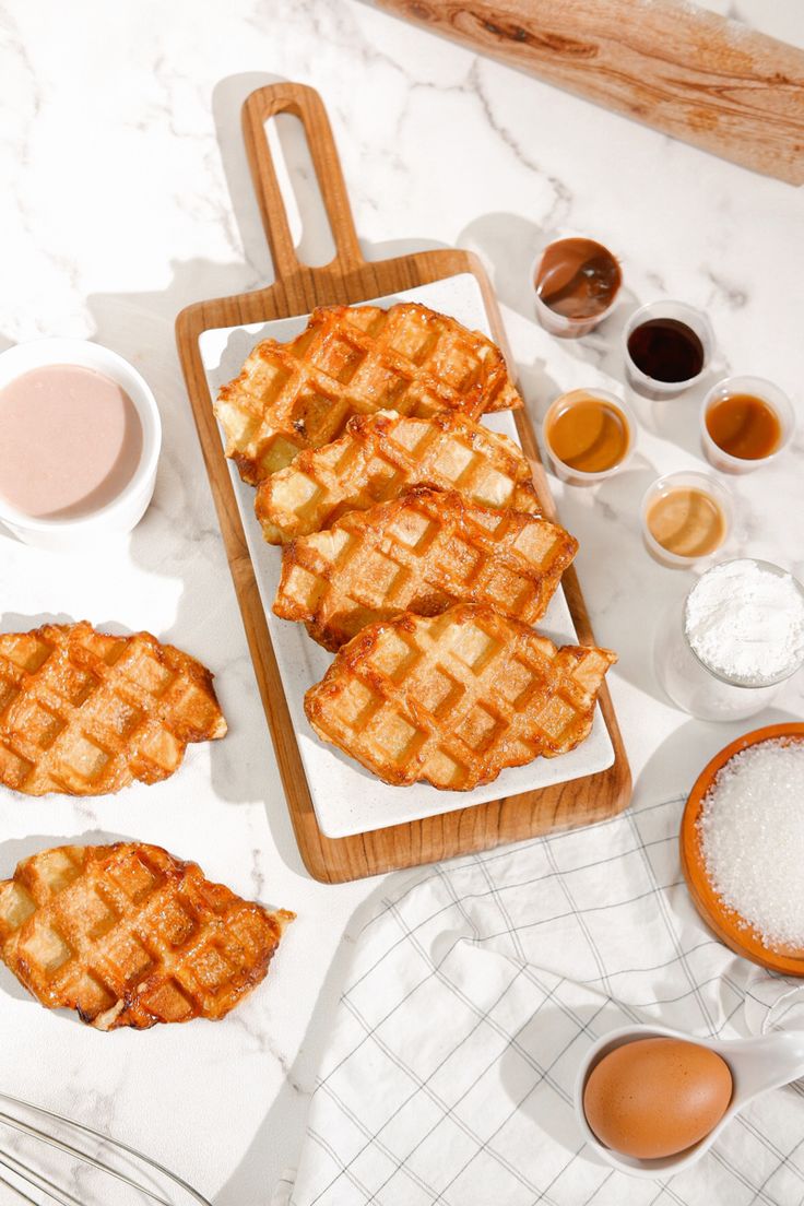 the waffles are ready to be eaten on the table with other ingredients around them