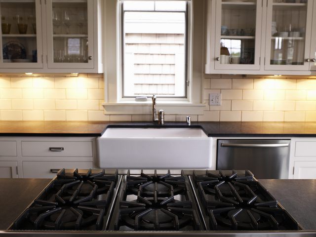 a stove top oven sitting inside of a kitchen