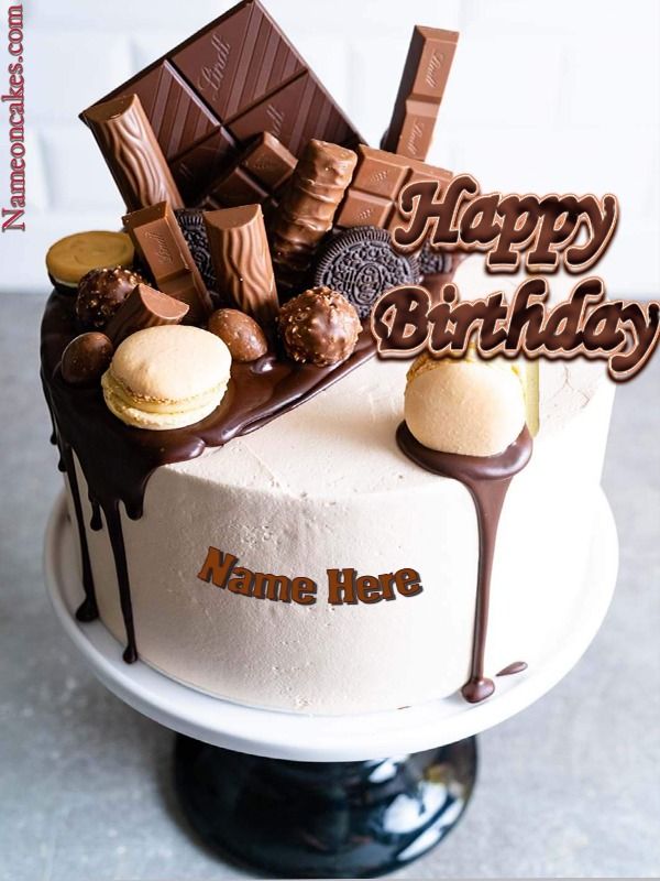 a birthday cake with chocolate and candy on the top that says, happy birthday name here