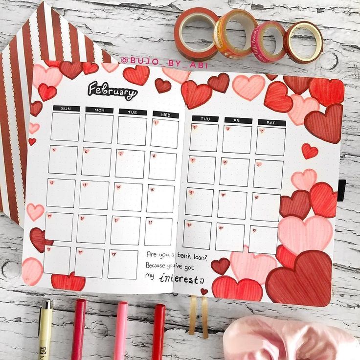 a planner with hearts on it next to some scissors and other items that include tape